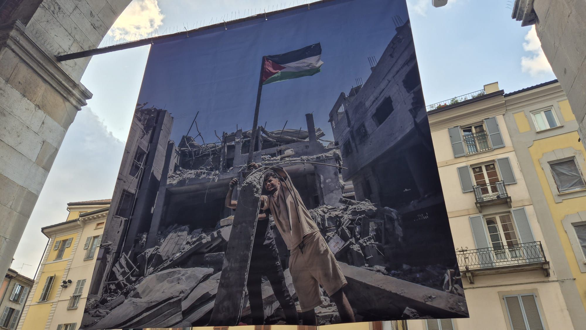 Sotto i portici di Palazzo Gotico il richiamo alla pace e alla dignità umana con le gigantografie del progetto "I Grant You Refuge" ferrari